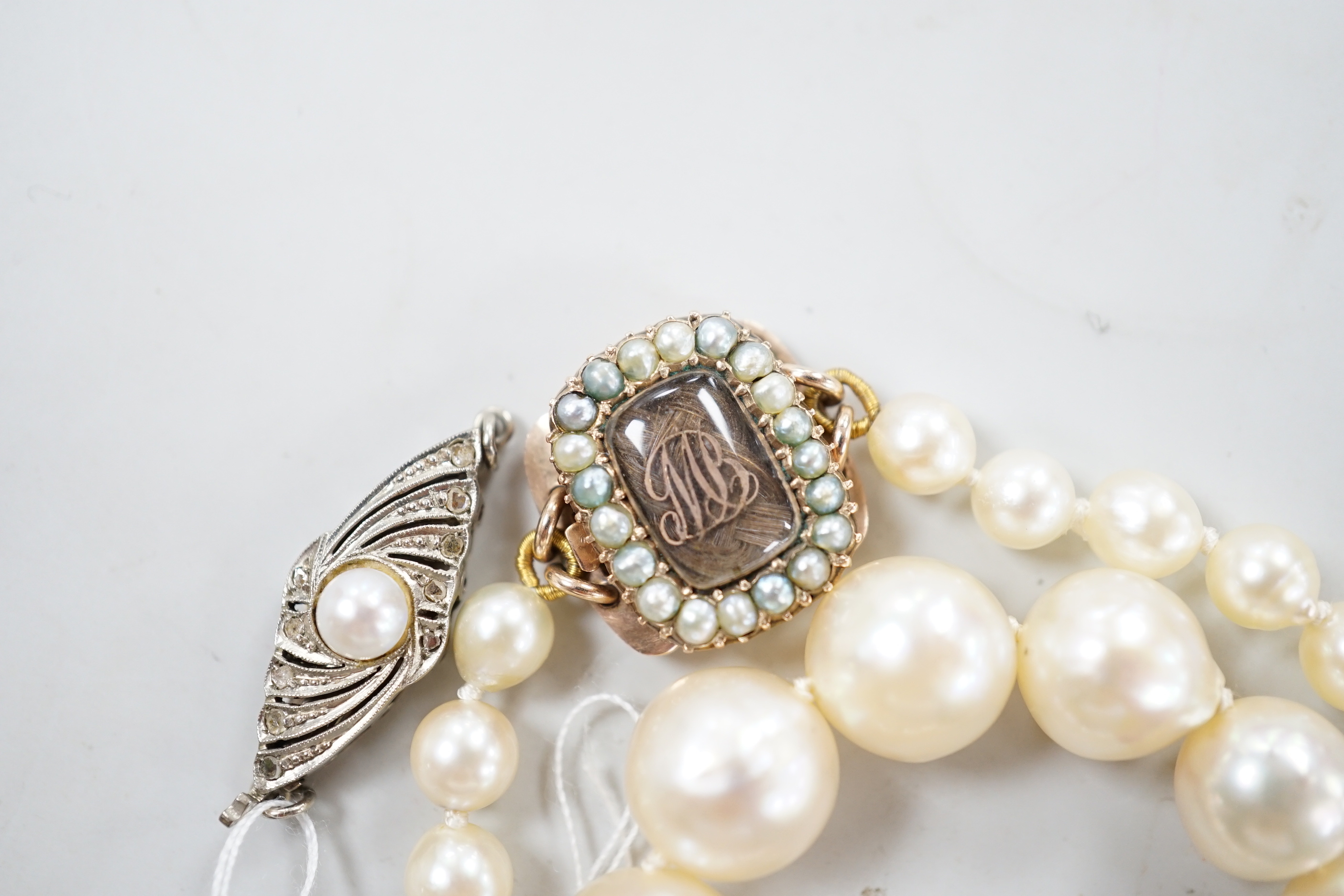 A single strand graduated cultured pearl necklace, now with an earlier 19th century seed pearl and plaited hair set clasp, 76cm, together with original clasp.